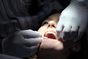 patient getting her teeth checked by a Willoughby emergency dentist